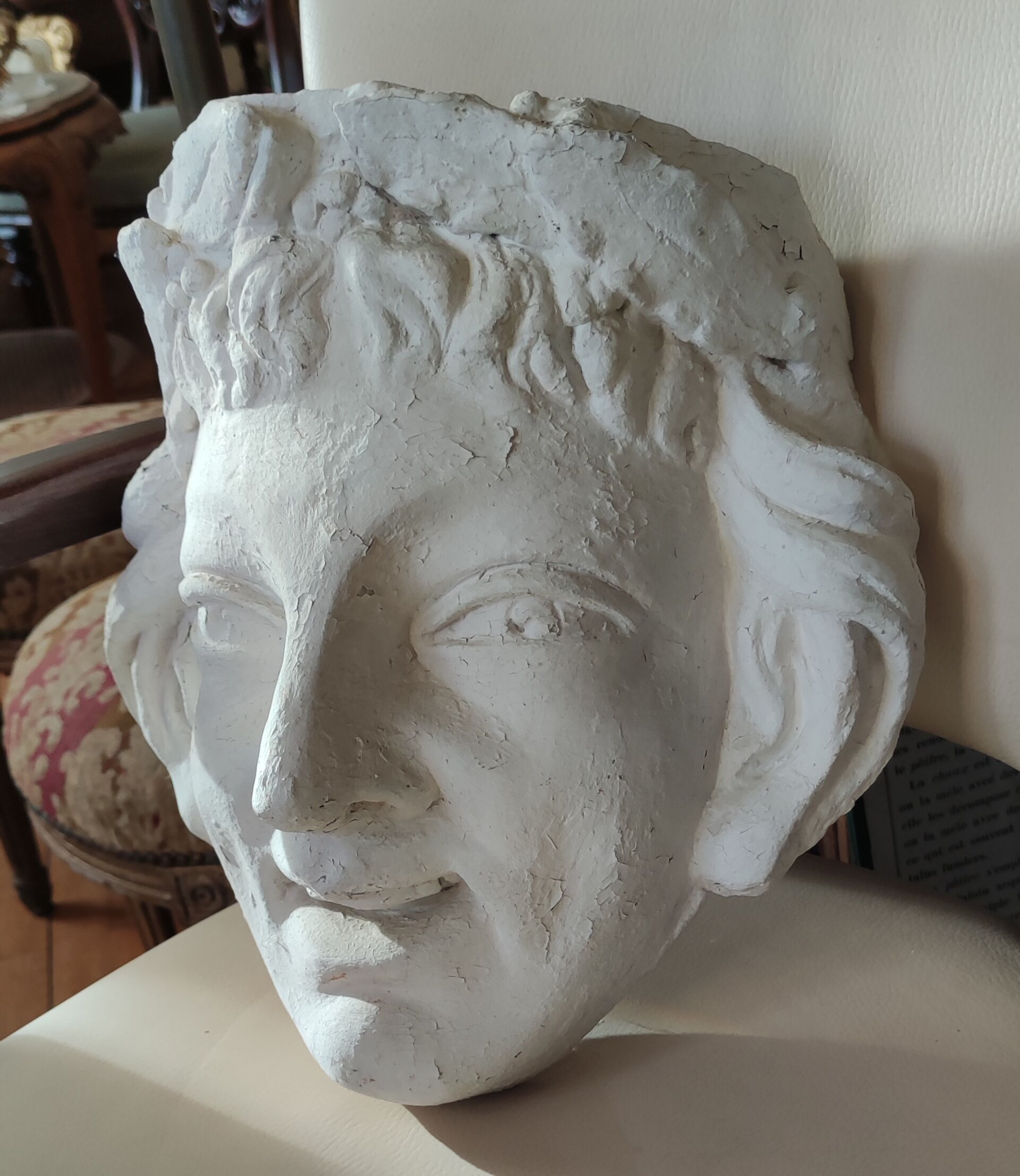Old face in plaster antique decoration