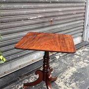 19th-century solid mahogany table with a tilting top and brass mechanism.