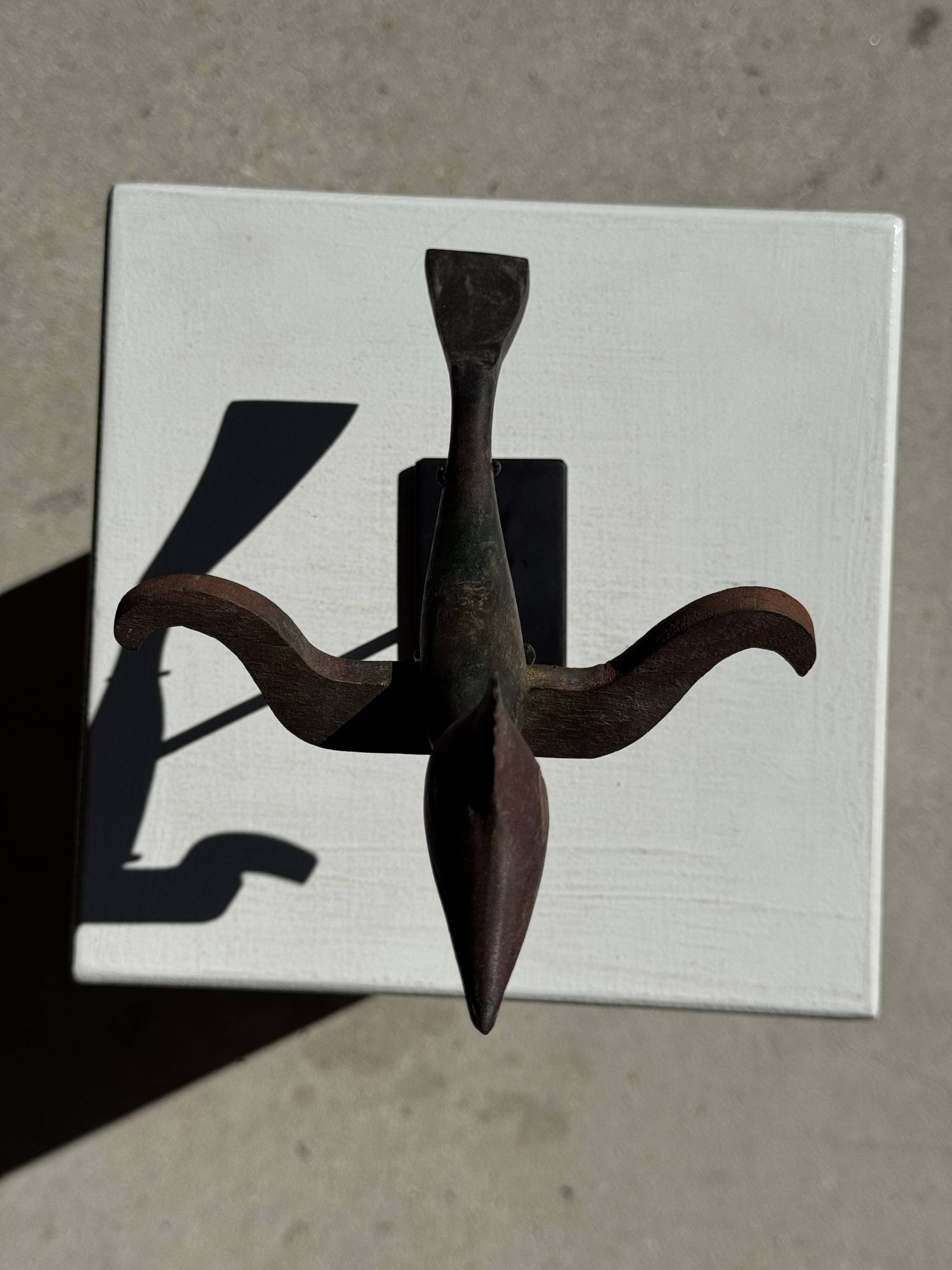 Traditional Indonesian decorative wooden bird on a base, crest model.