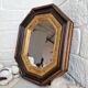 Miroir ancien en bois octogonal noir et doré