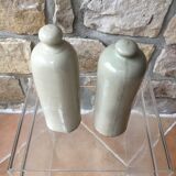 Lot of two old bottles of beige enamelled sandstone bottles