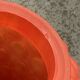 Small Art Deco ball vase in red-orange tinted glass