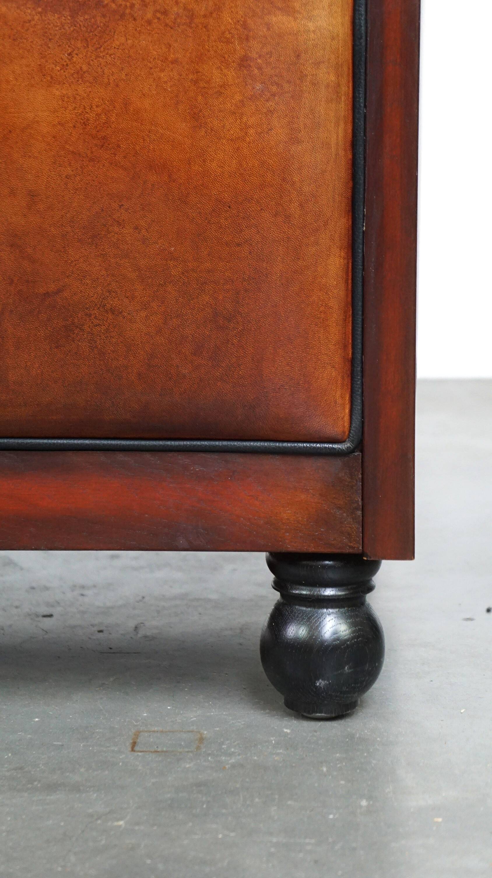 Sheepskin Art Deco design armchair with wood and beautiful cognac-colored leather