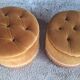 False pair of round Napoleon III poufs in ochre velvet, tufted with fringes.