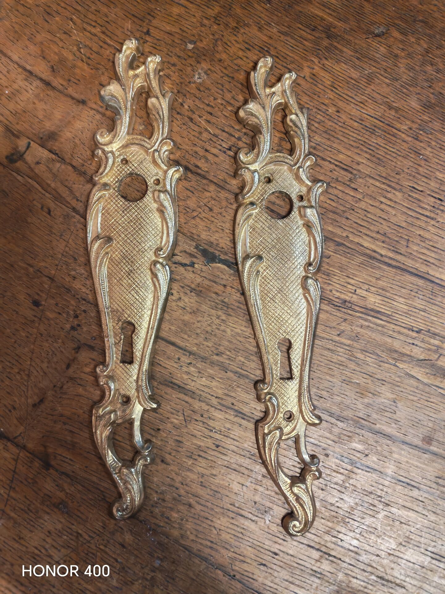 Pair of solid brass cleanliness plates in Louis XV rococo style.