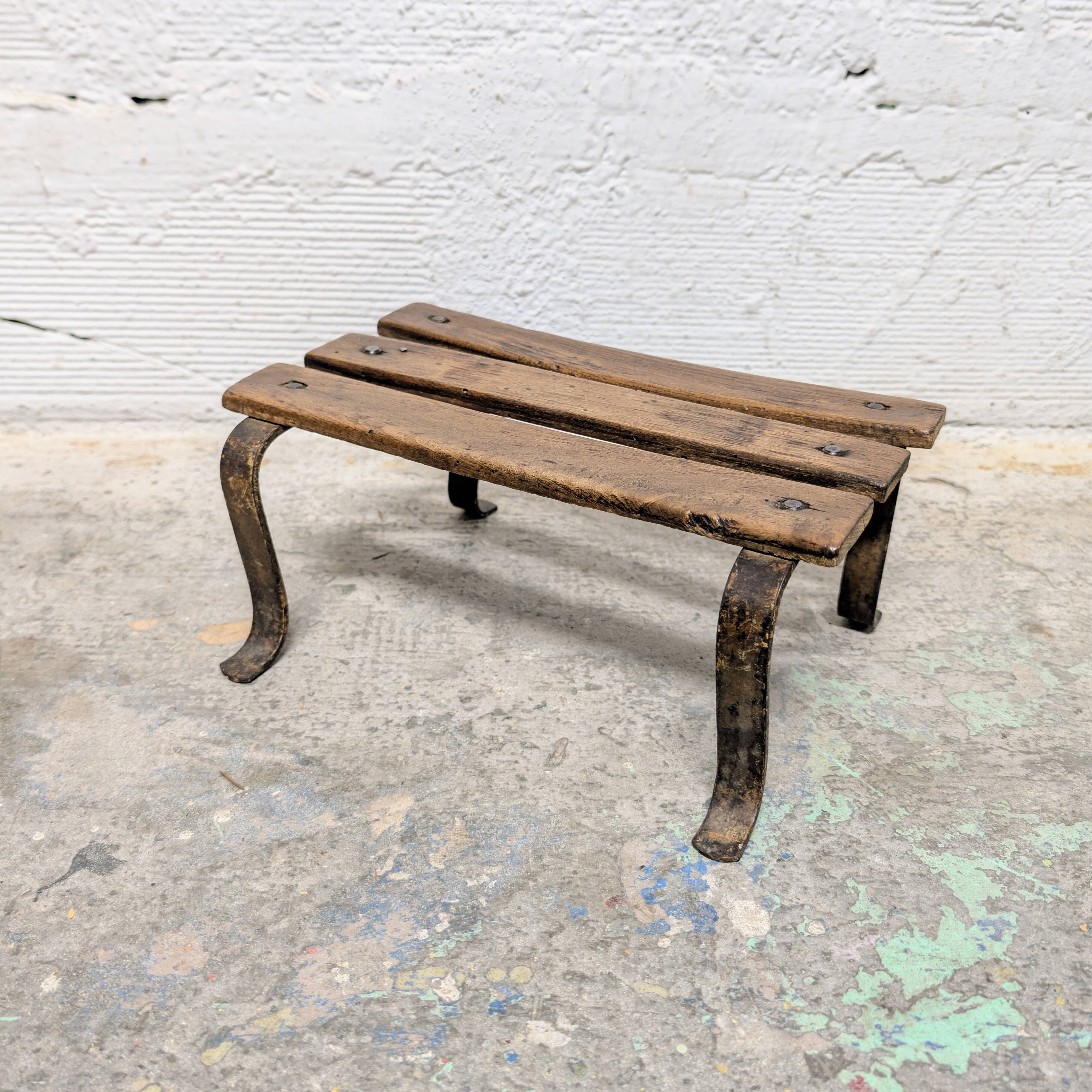 Antique iron and wood footrest