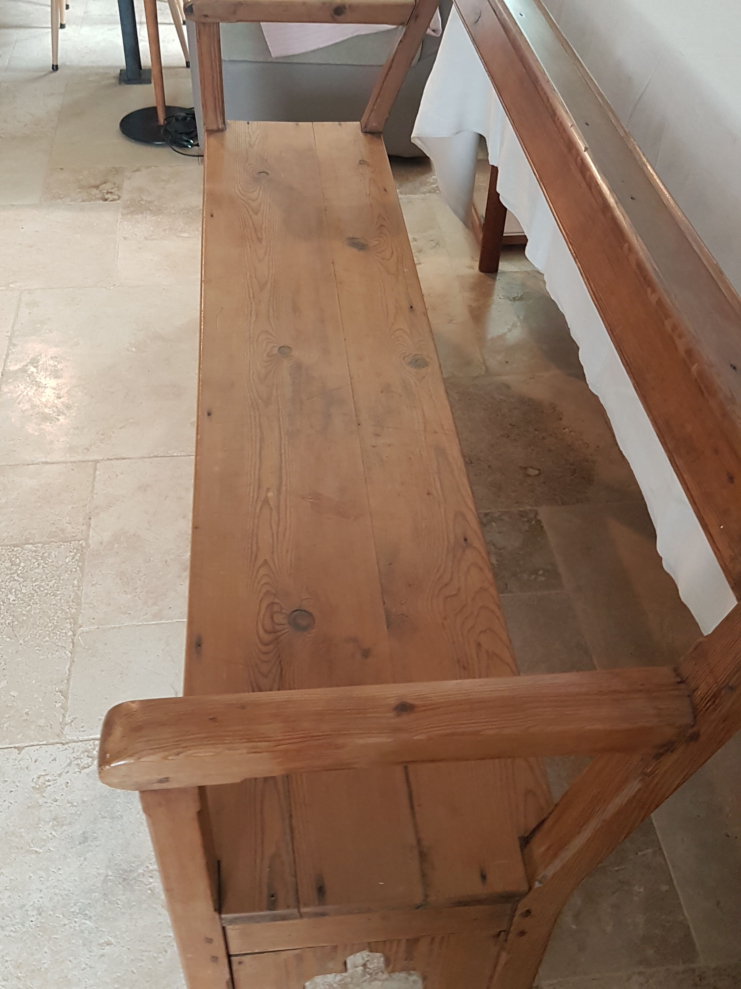 Church bench in fir tree with armrests