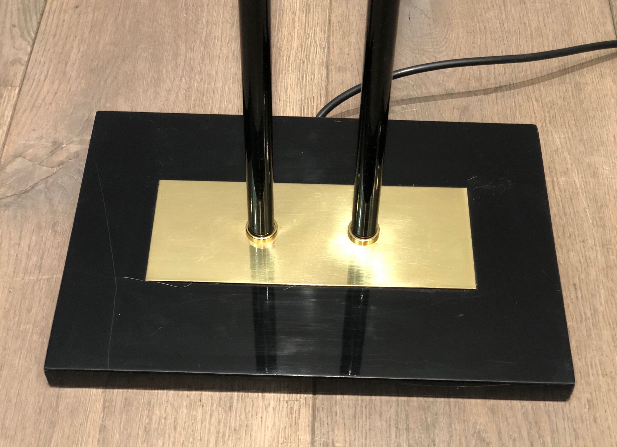 Black lacquered metal floor lamp with brass.