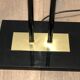 Black lacquered metal floor lamp with brass.