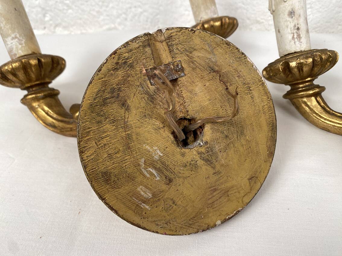 Pair of gilded wooden wall lights with two arms, early 20th century.