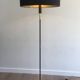 Designer floor lamp in black lacquered metal and brass