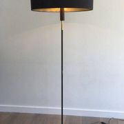 Designer floor lamp in black lacquered metal and brass