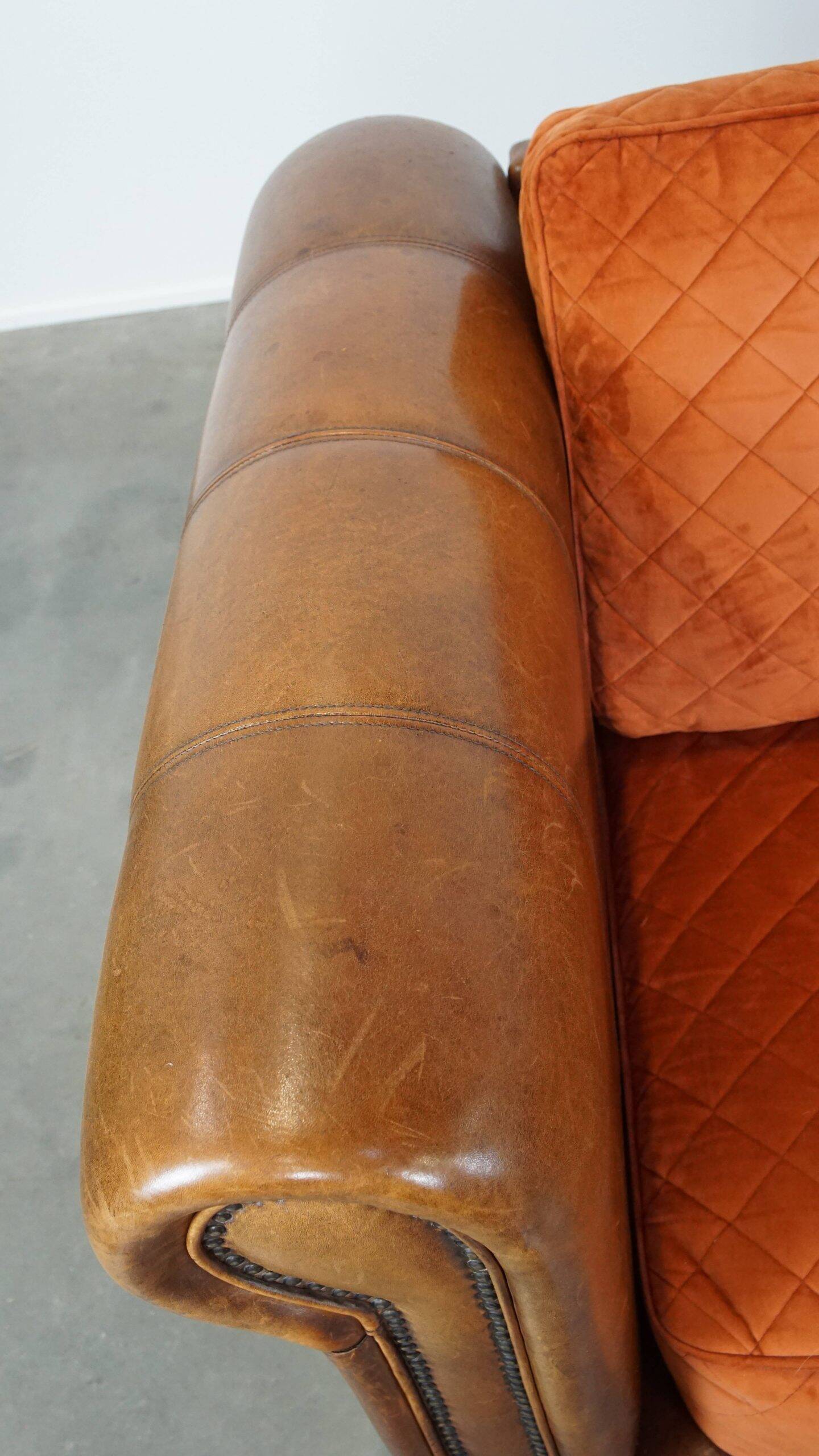 Luxury and comfortable sheepskin 2.5-seater sofa of top quality with orange fabric seat and back cushions