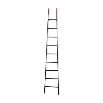 Old vertical ladder in industrial metal