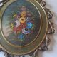 Painted under glass convex medallion in bronze