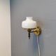 Older wall lamp, in metal, brass and milk-white glass