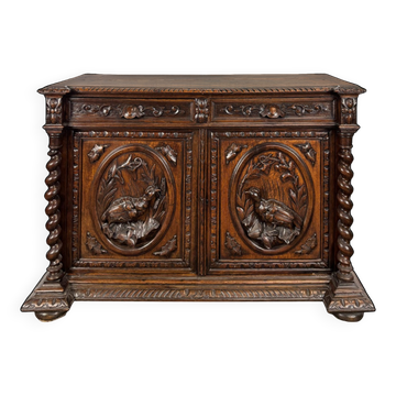 Henri II style hunting buffet in carved oak with twisted columns.