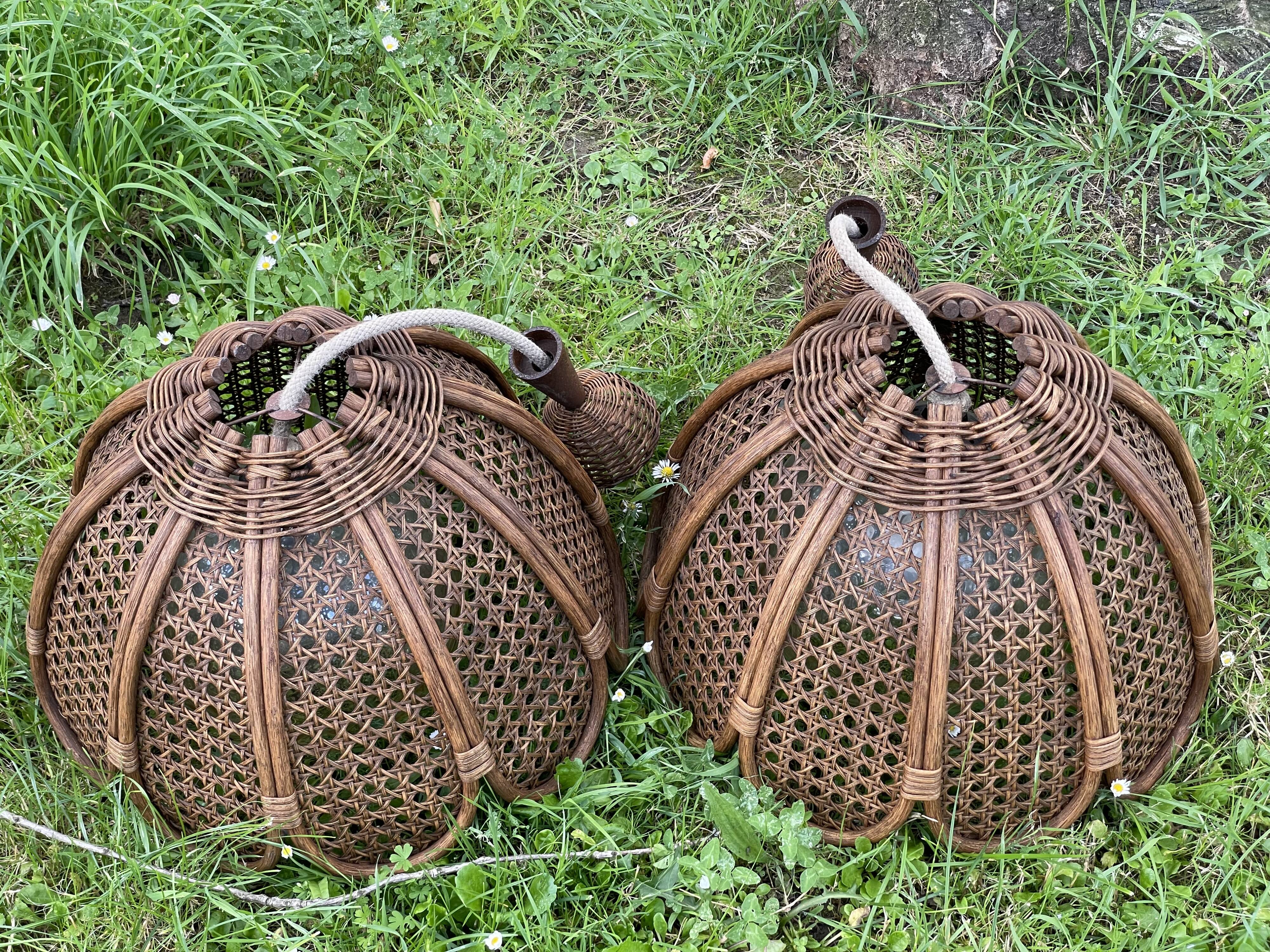 Duo of rattan and glass chandeliers