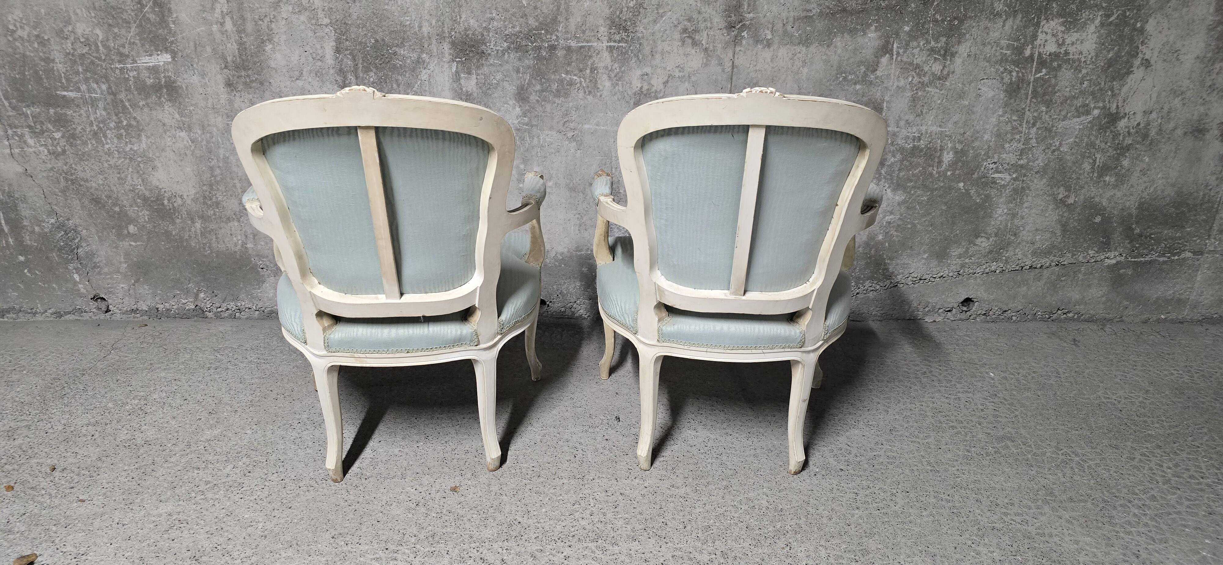 Pair of Louis XV style armchairs in patinated wood, light blue fabric.