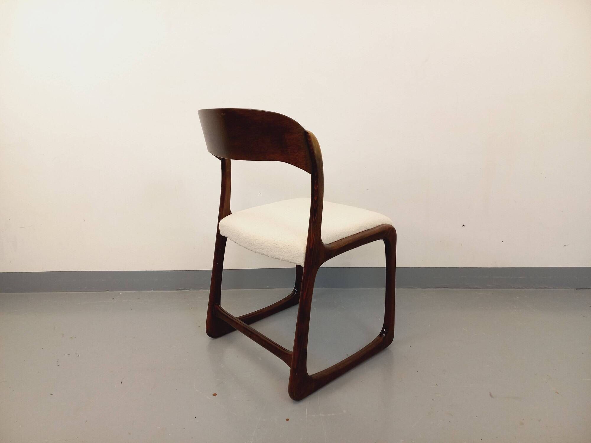 Vintage sled chair by Baumann in wood and boucle fabric.