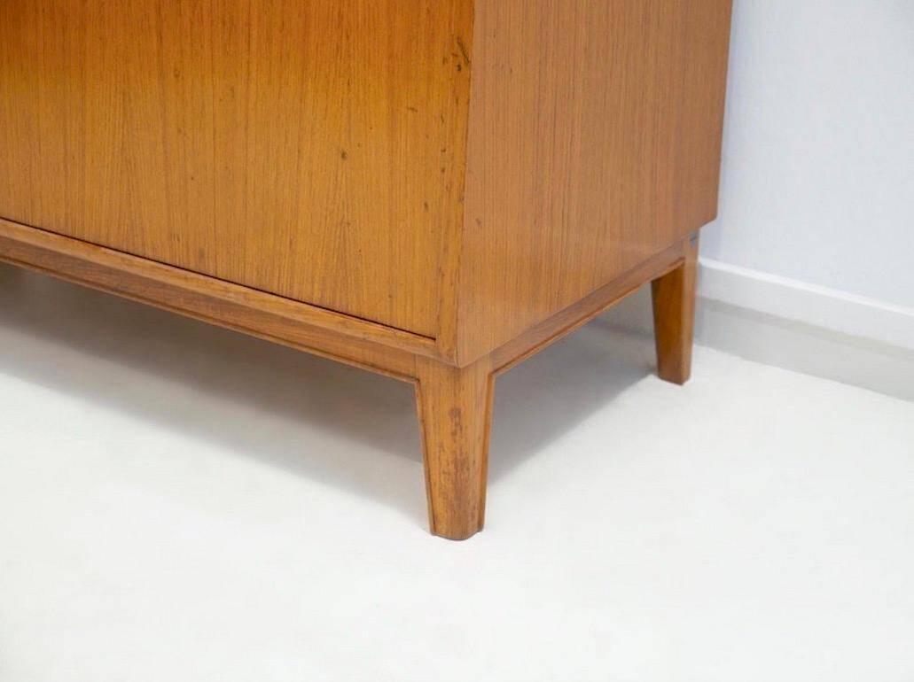 Modern Scandinavian wardrobe in teak with sliding doors and drop-down flap.
