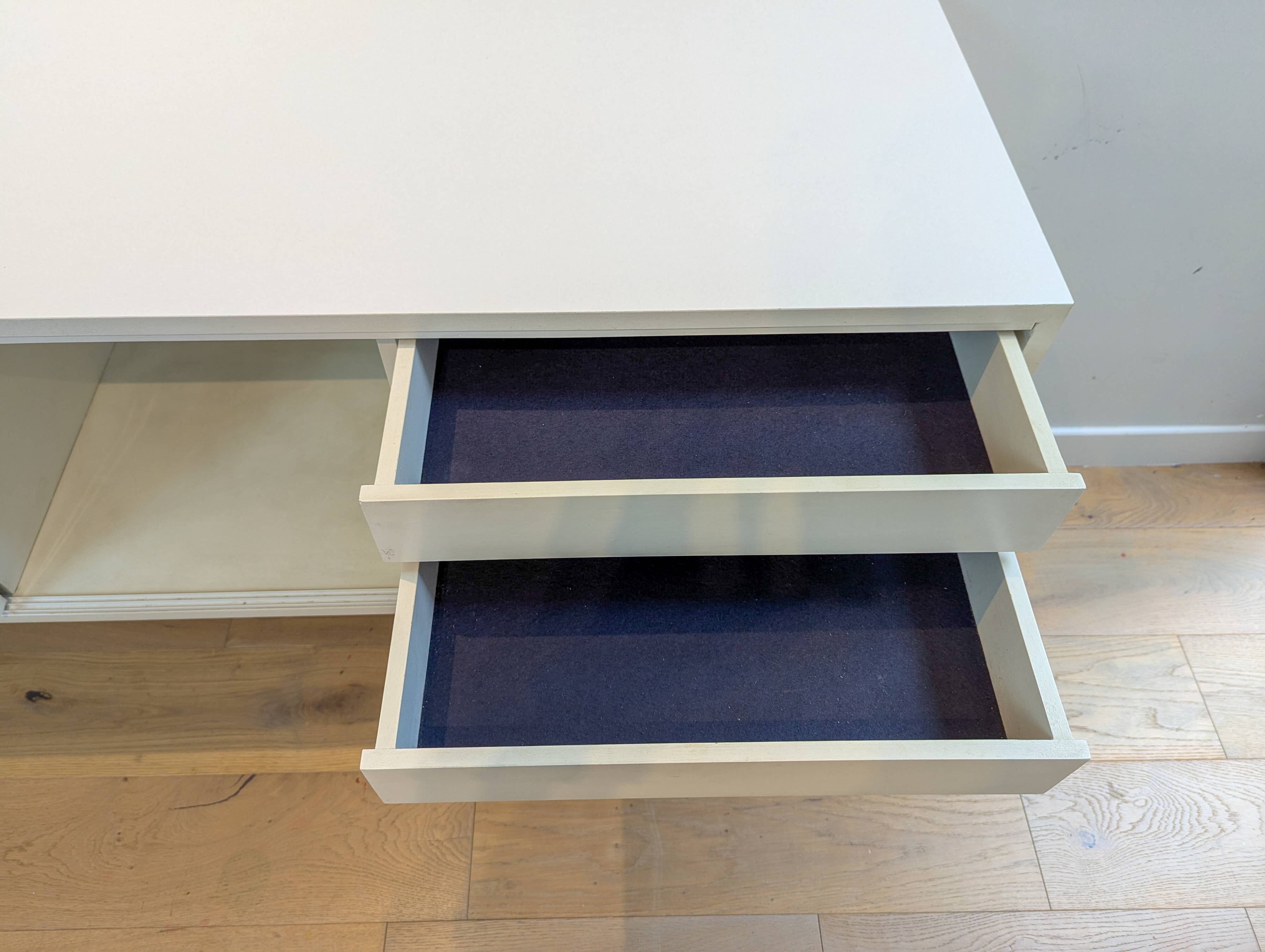 A vintage mid century space age sideboard with white sliding doors