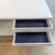 A vintage mid century space age sideboard with white sliding doors