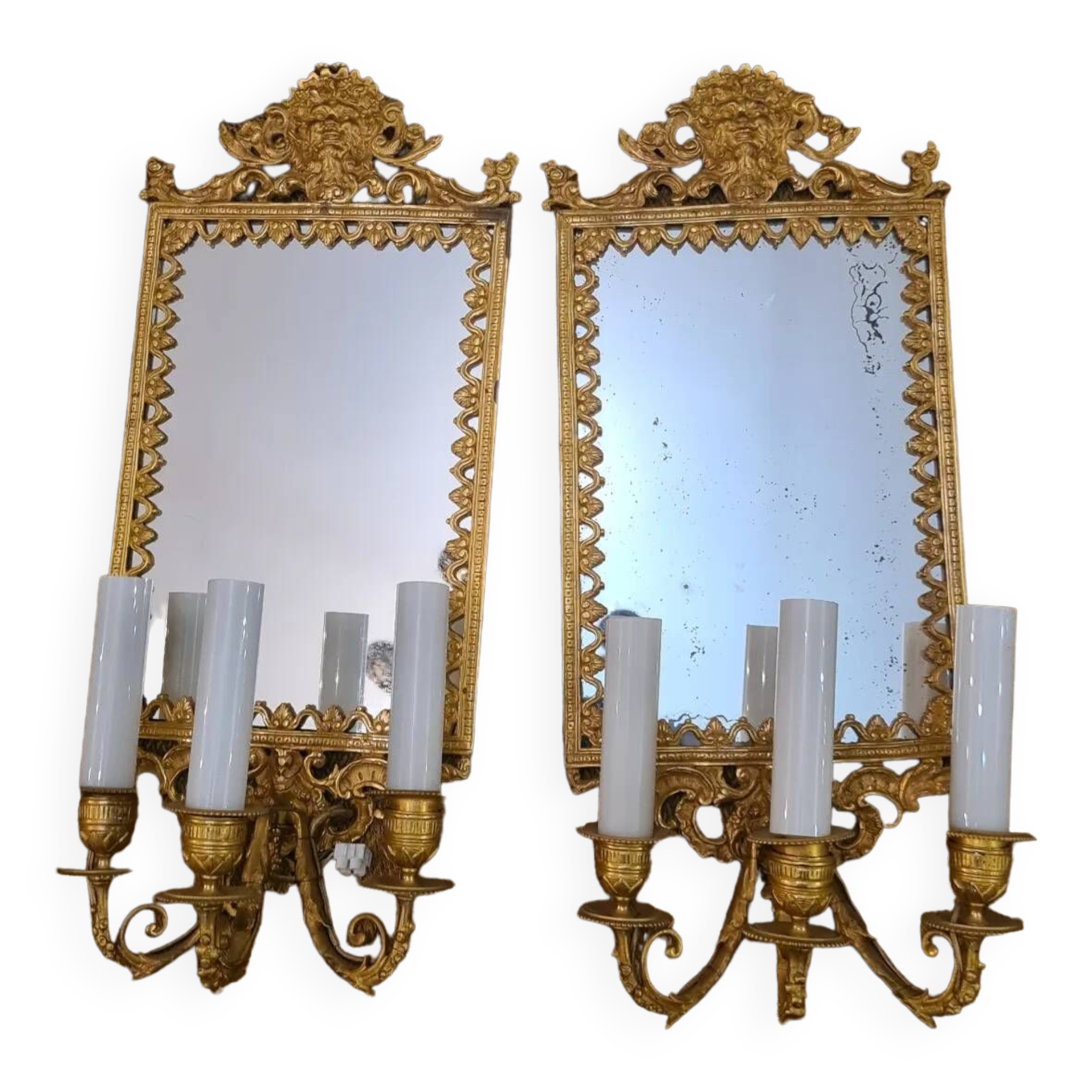 Pair of wall lights with mirror backgrounds with 3 arms of lights in chiseled and gilded bronze. framing decorated with foliage and masks. louis xiv style