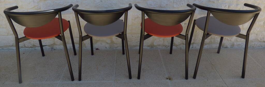 4 gondola-style chairs with a sturdy metal frame and faux leather.