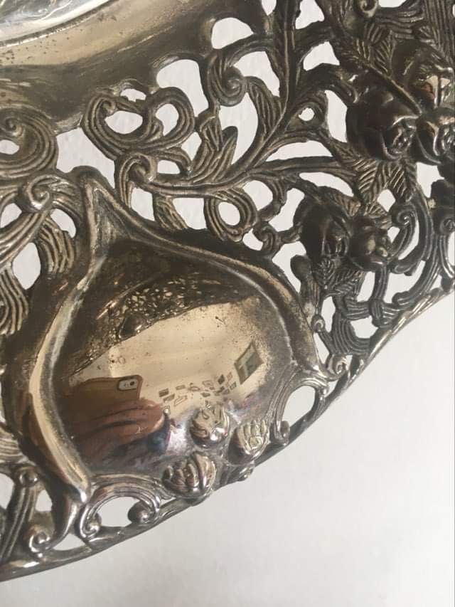 Silver metal basket with floral decoration