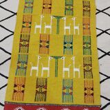 Mustard colored carpet with gazelle patterns berber style