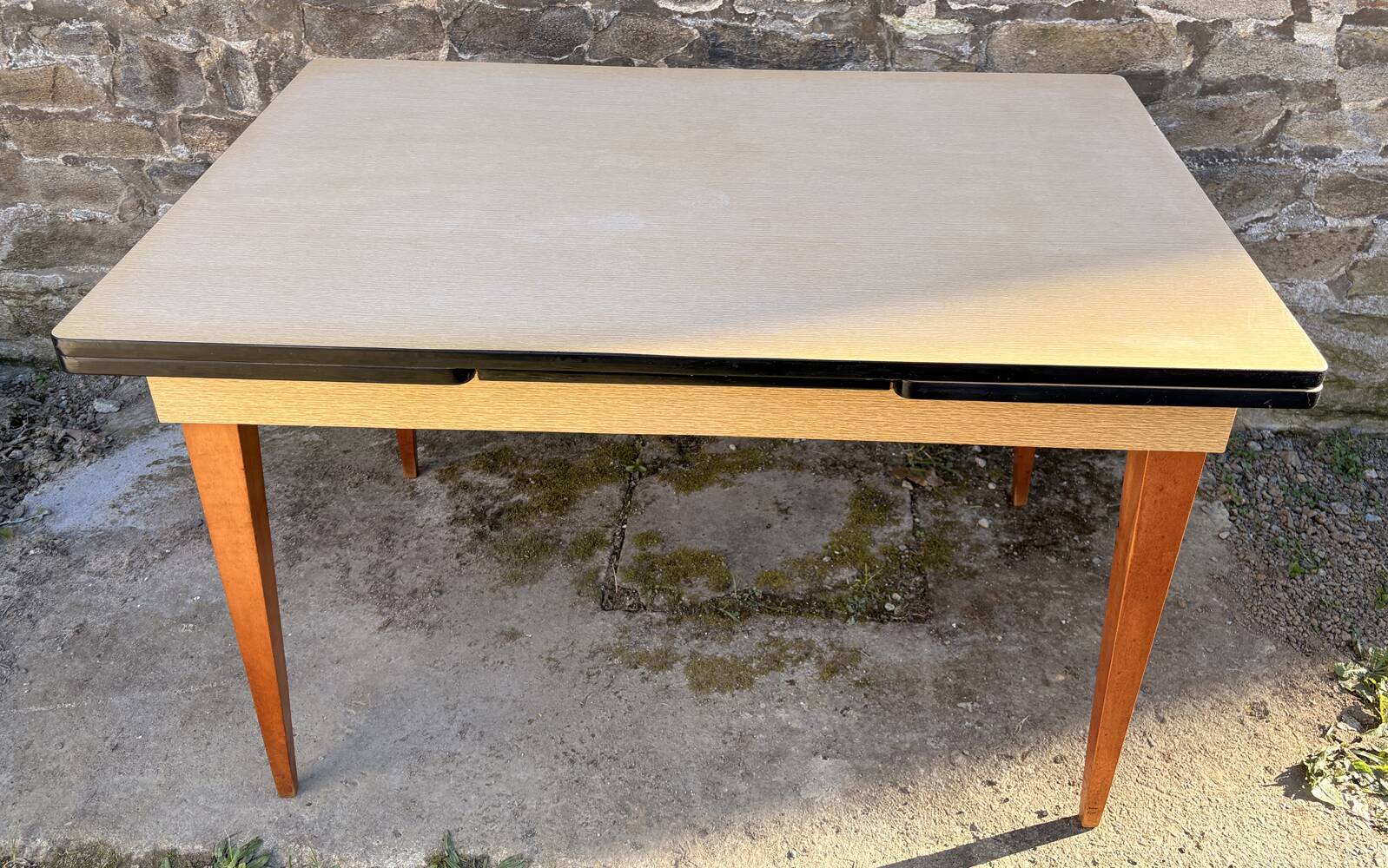 Beige French modernist extendable table, wooden legs, circa 1955.