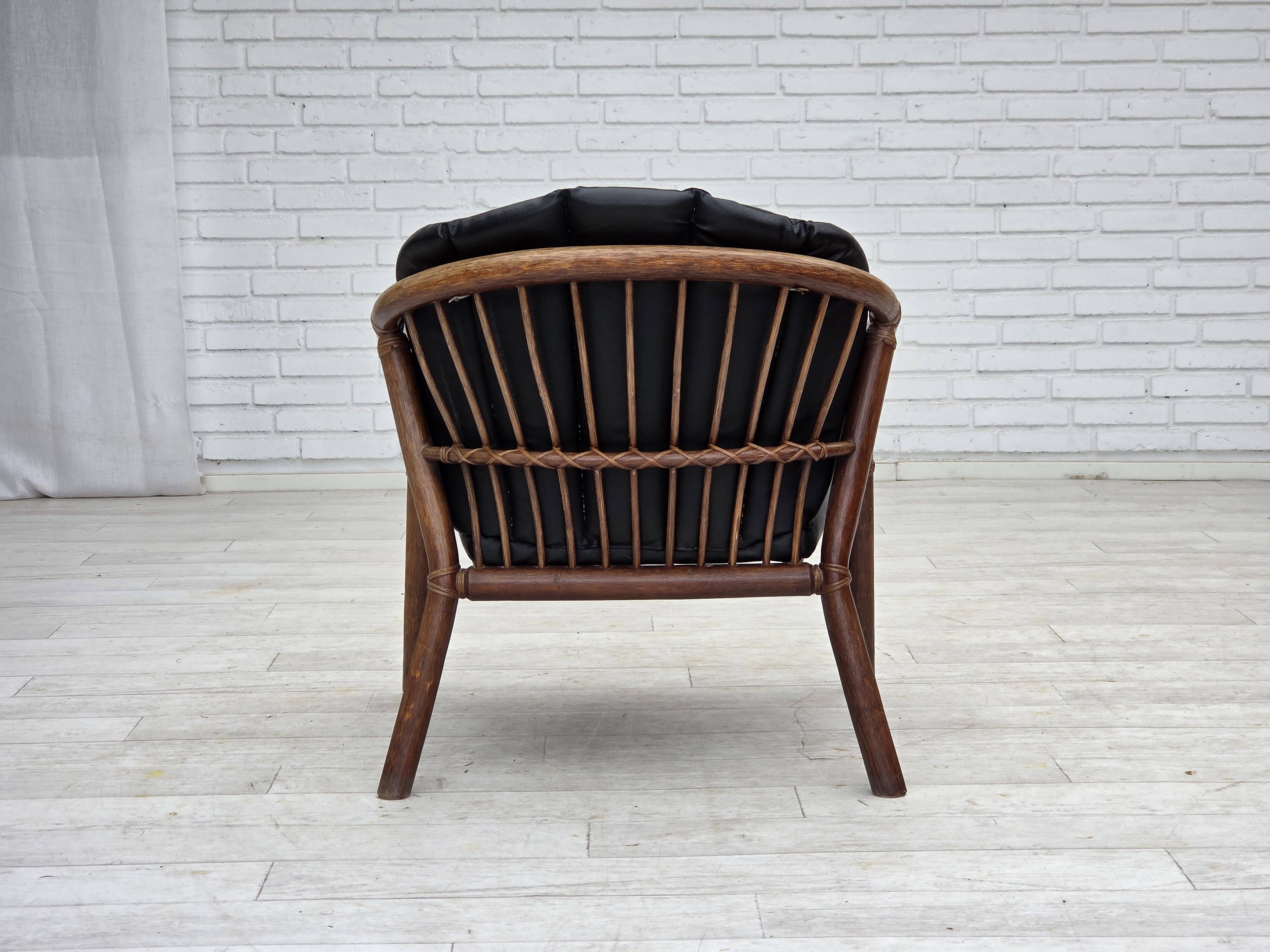1970s, Danish armchair, rattan, black artificial leather.