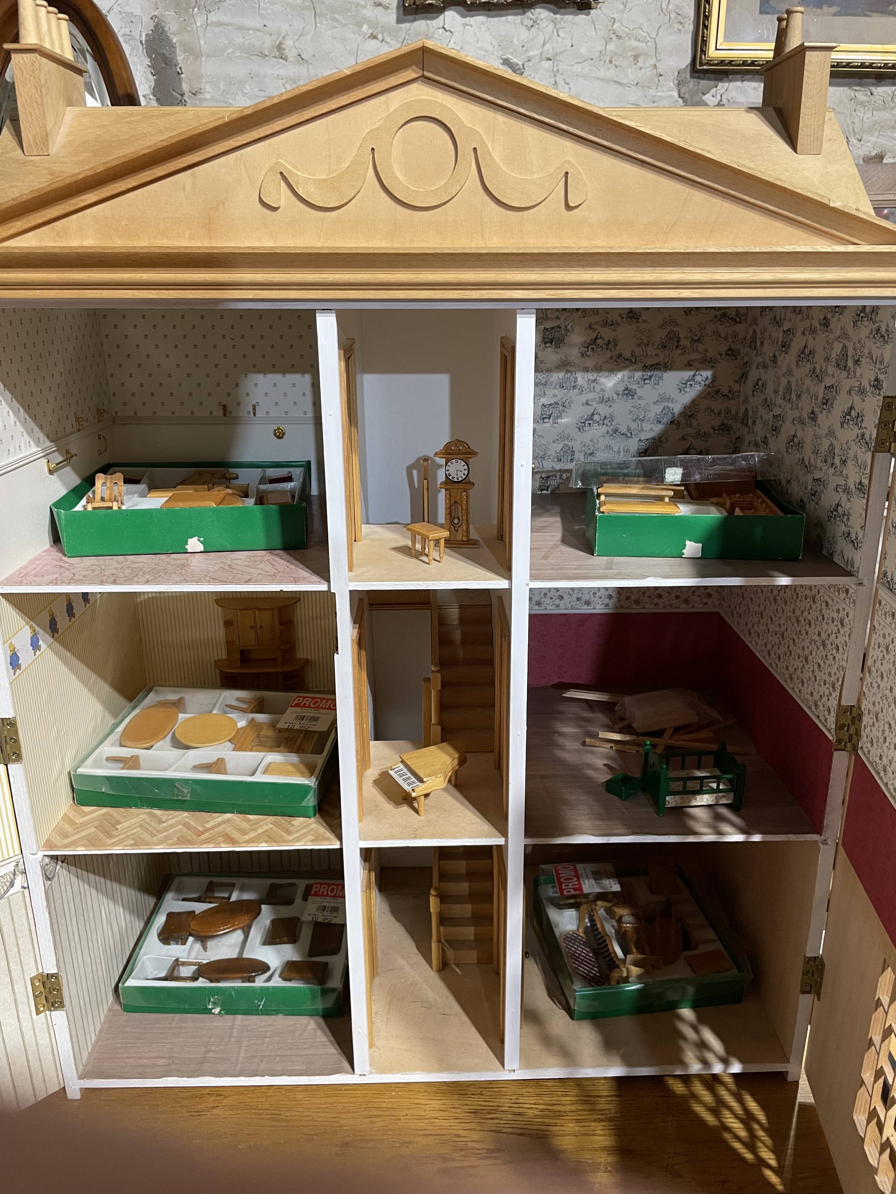 Large wooden dollhouse with miniature furniture