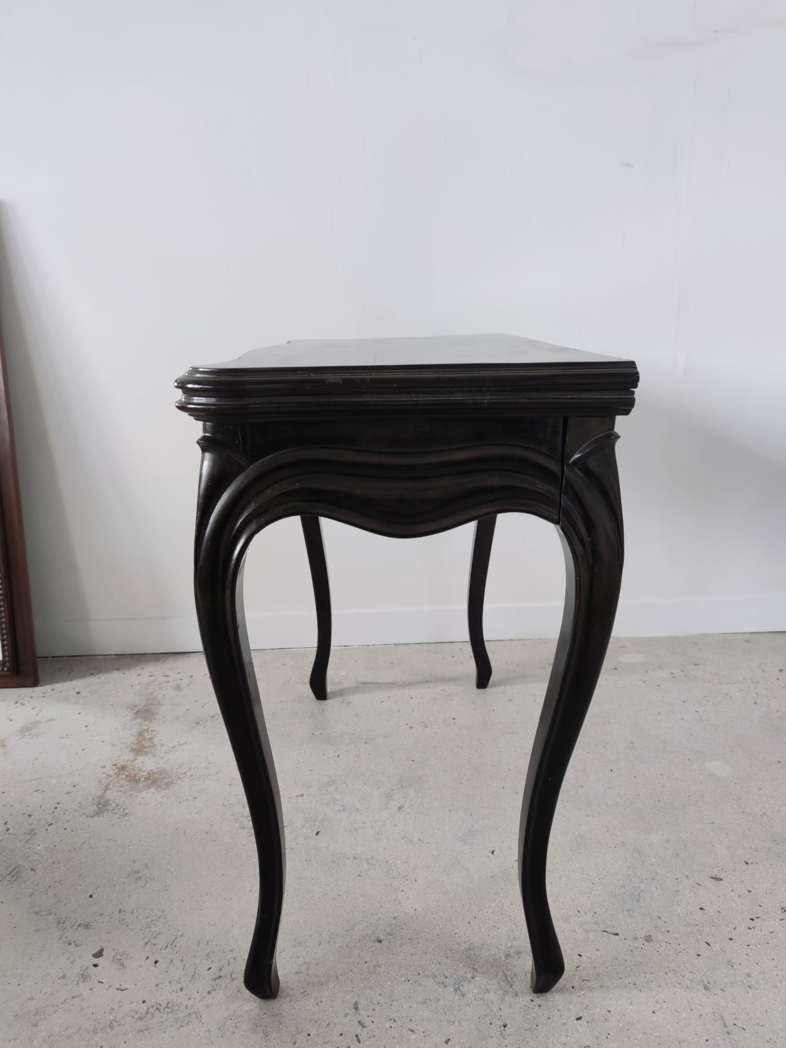 Molded blackened wooden play table, arched legs, green felt