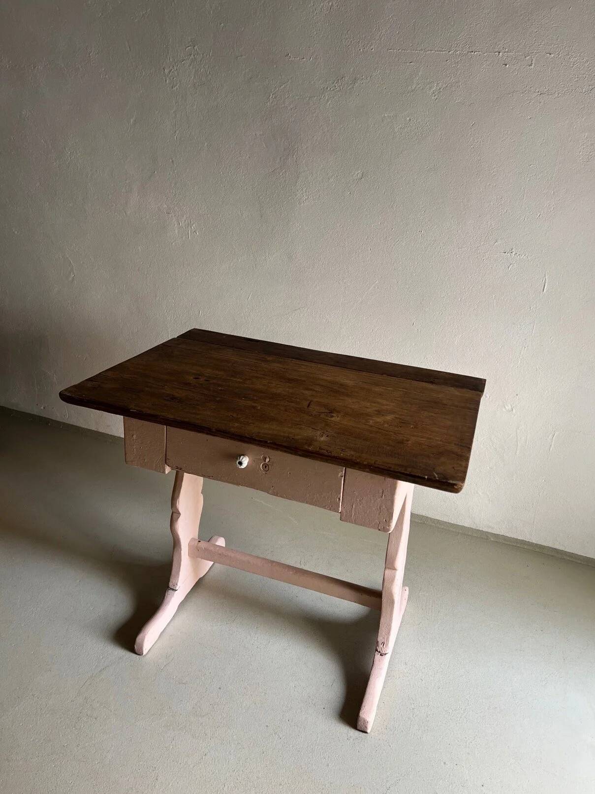 Rustic pink painted desk with brown tabletop
