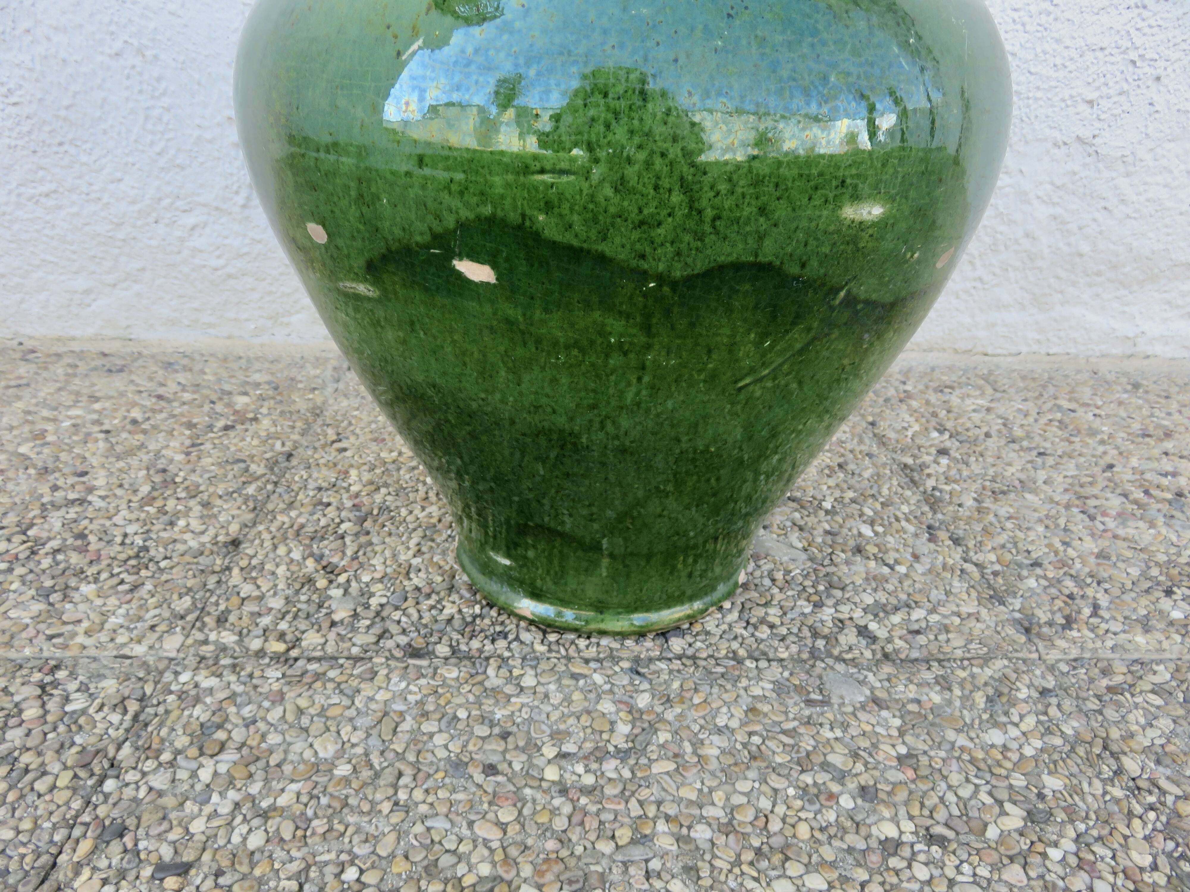 Antique glazed green terracotta oil jar, late 19th century.