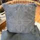 Blue crocheted bedspread and its vintage cushion
