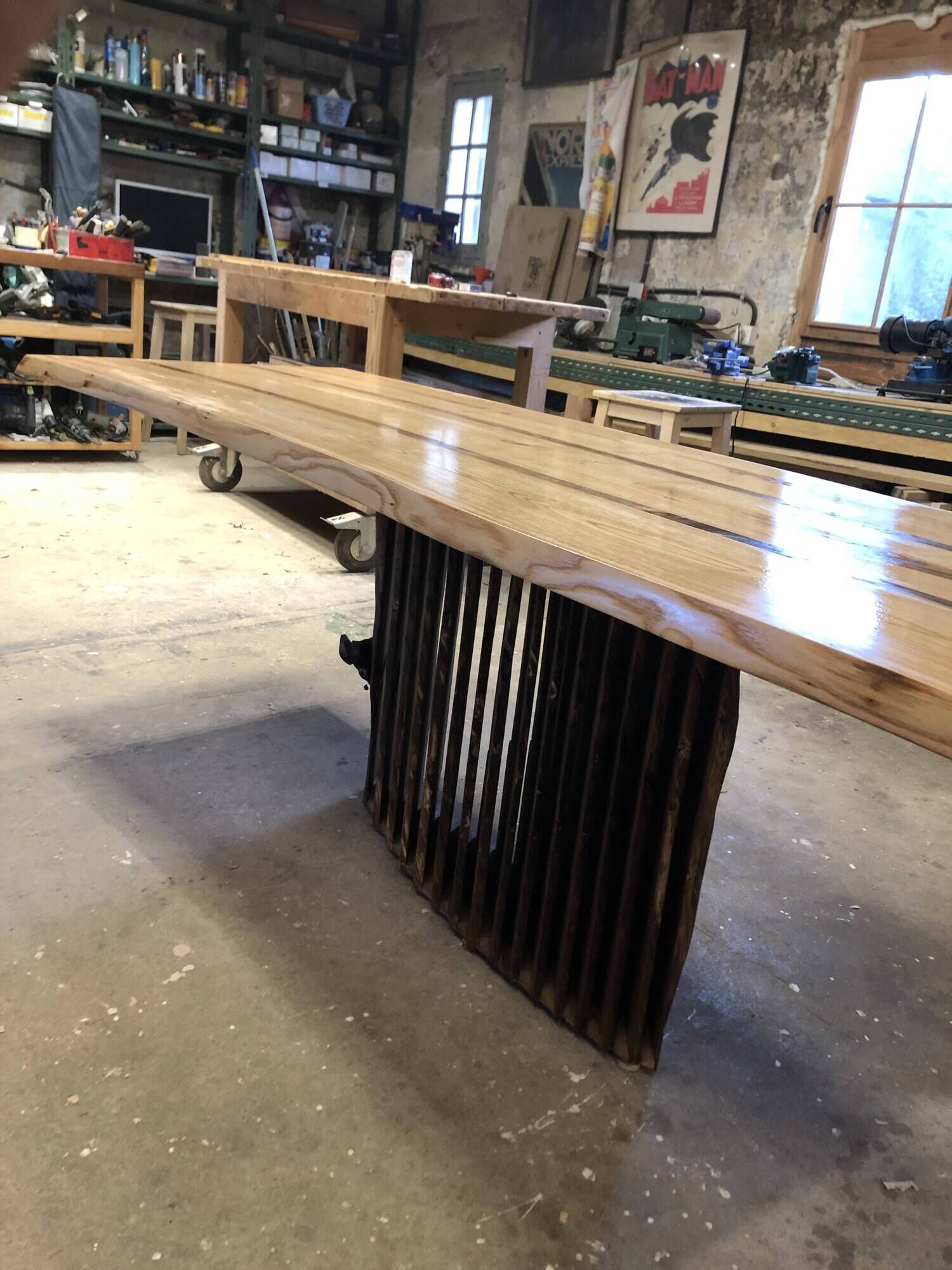 Chestnut and walnut solid table and benches with a central leg.