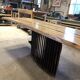 Chestnut and walnut solid table and benches with a central leg.