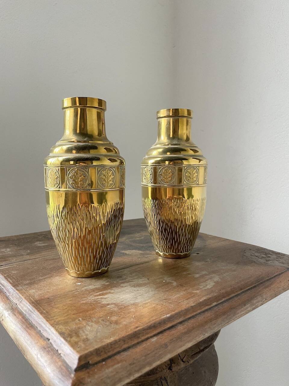 Duo of embossed brass vases