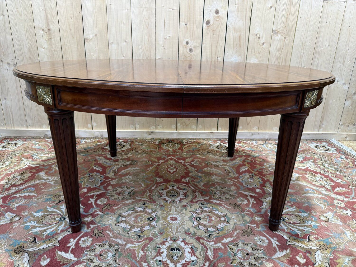 Oval dining table in Louis XVI style made of mahogany.