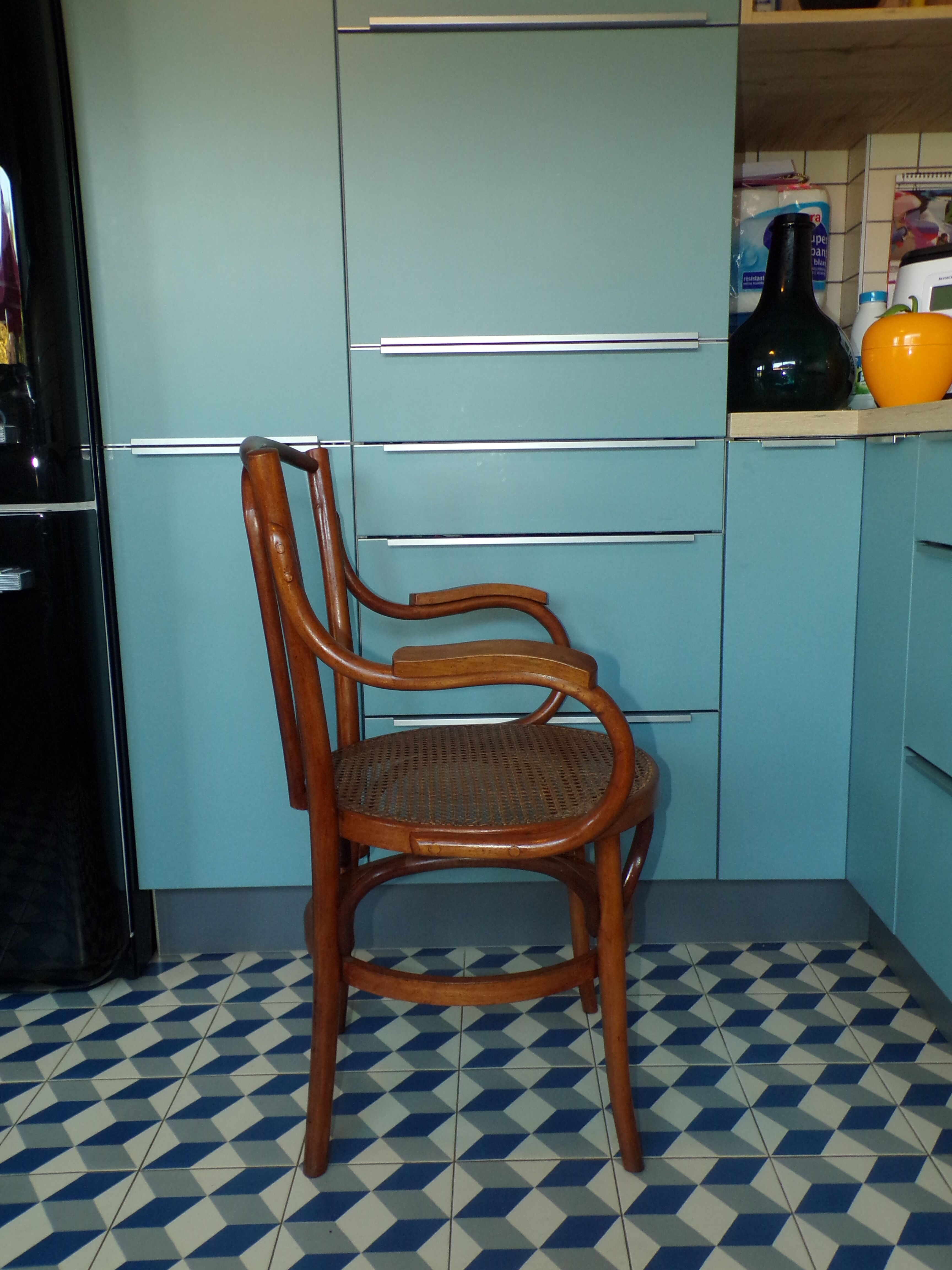 Old armchair in curved caned wood of 1900