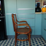 Old armchair in curved caned wood of 1900