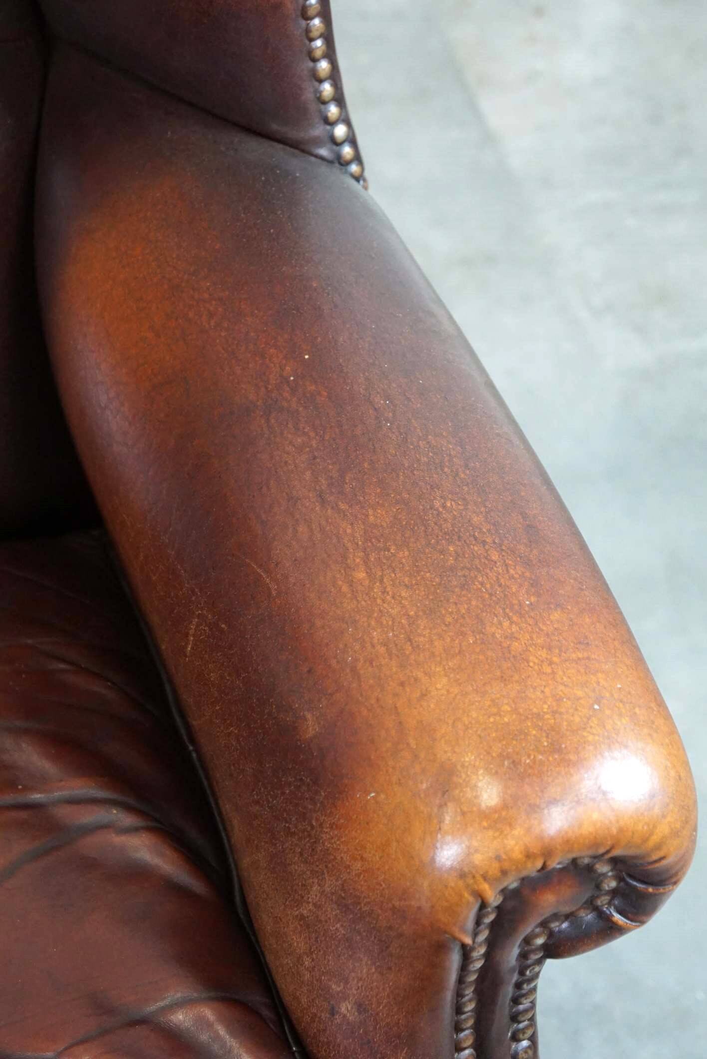 Beautiful classic and stately wingback armchair made of sheep leather with beautiful colors