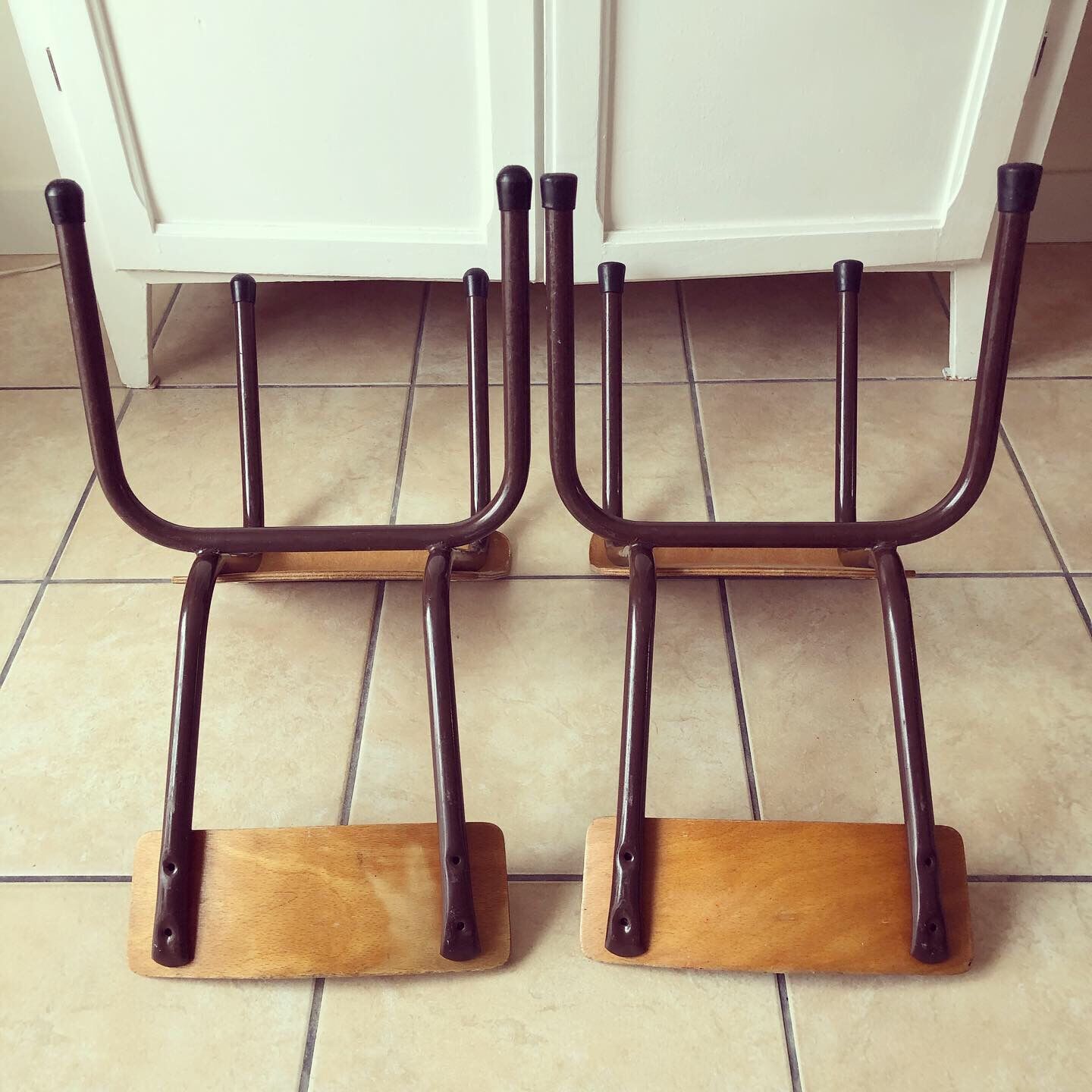 Duo of brown child school chairs