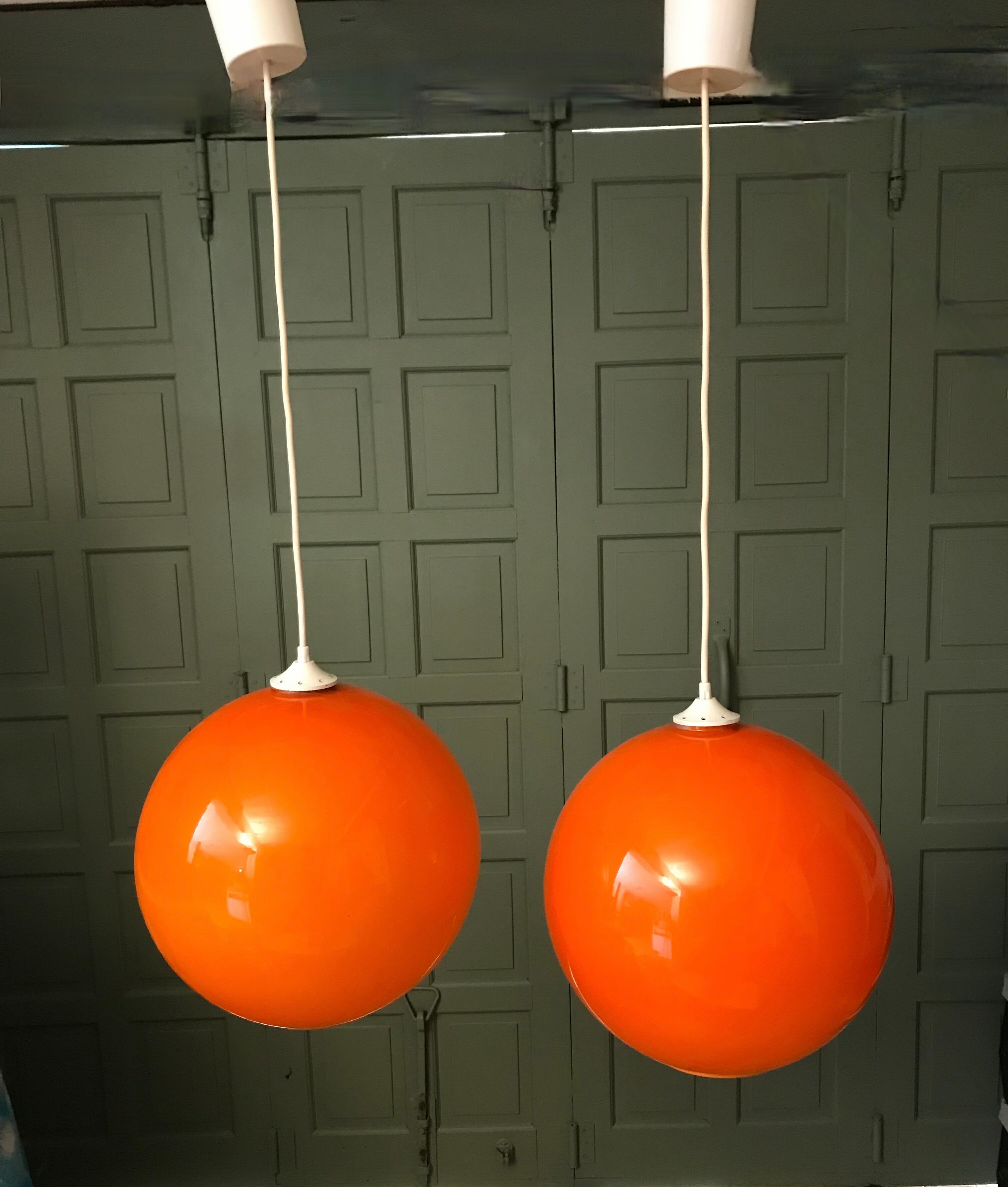 Pair of orange glass ball suspensions, 70s.