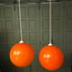 Pair of orange glass ball suspensions, 70s.