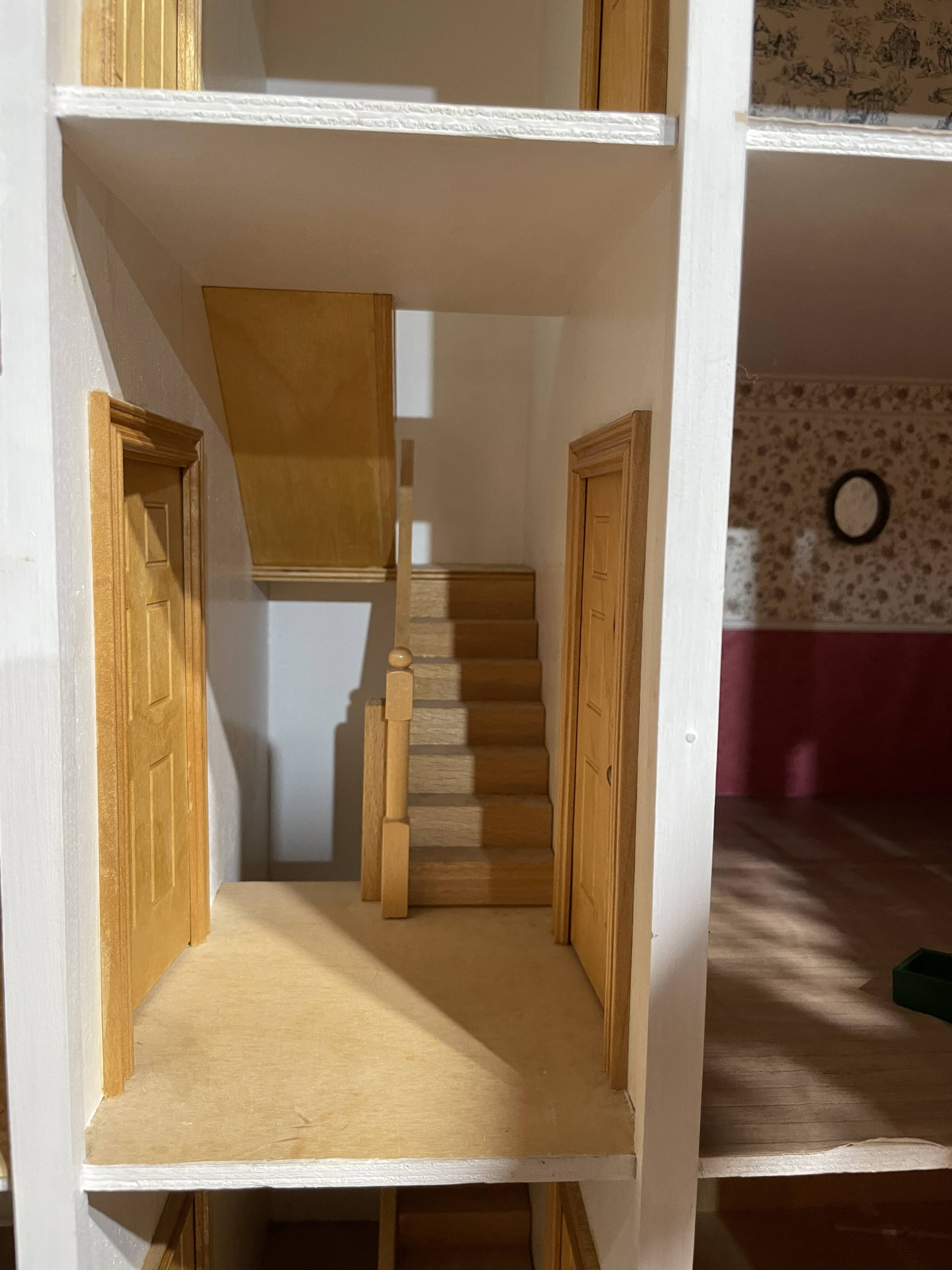 Large wooden dollhouse with miniature furniture