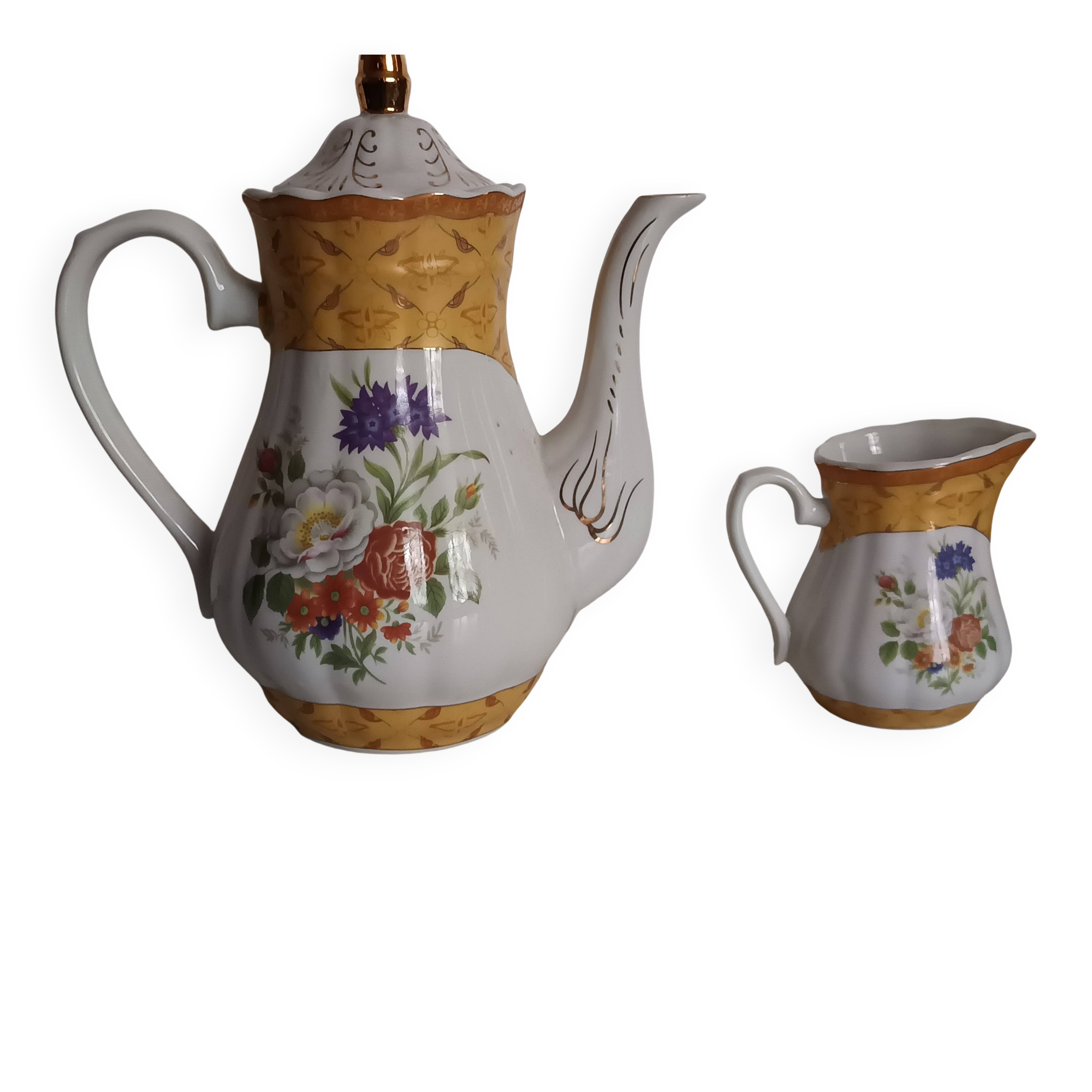 Golden porcelain teapot and coffee pot set with floral design and matching milk jug.